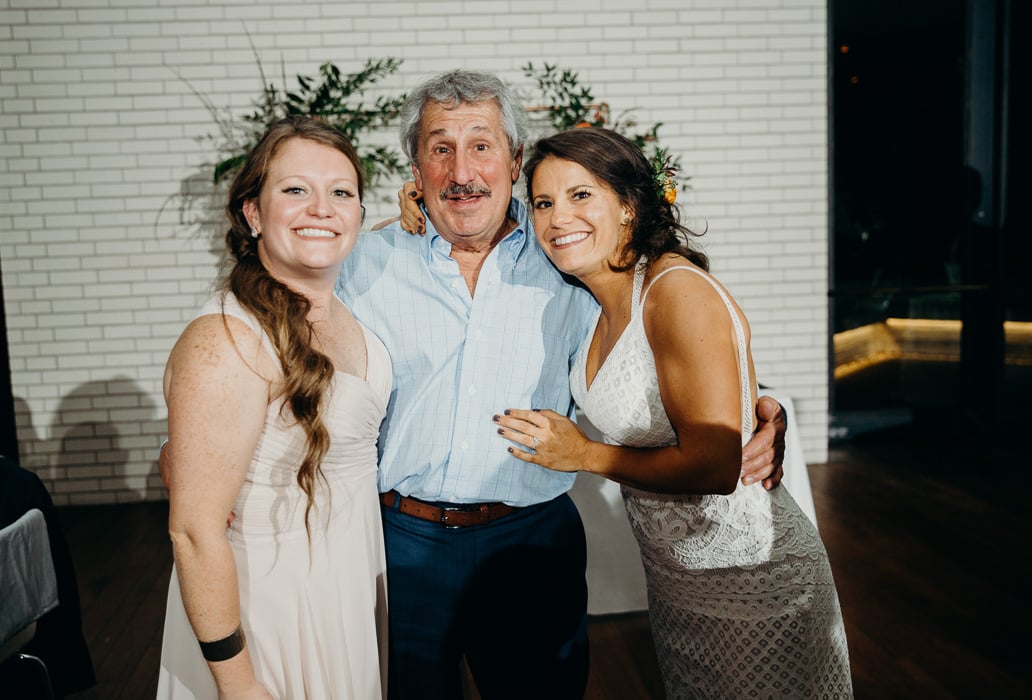 Father and his two daughters on one of his daughter's wedding day.
