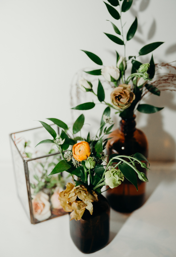 Rosebud vases filled with small flowers and greens.