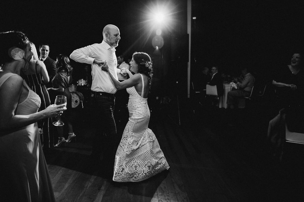 Bride dancing with a guest at her wedding.