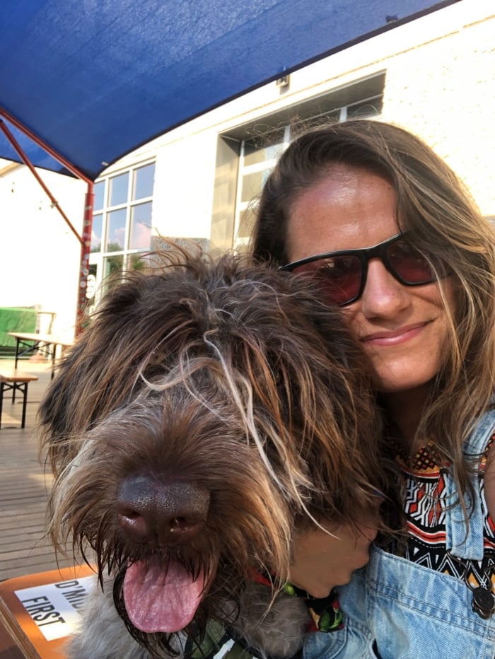 A girl taking a selfie of her and her wirehaired pointing griffon