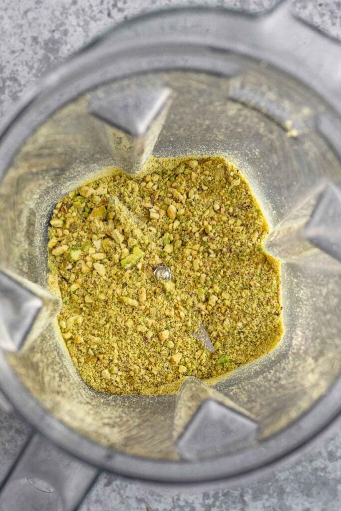 Blender filled with ground up pistachios.