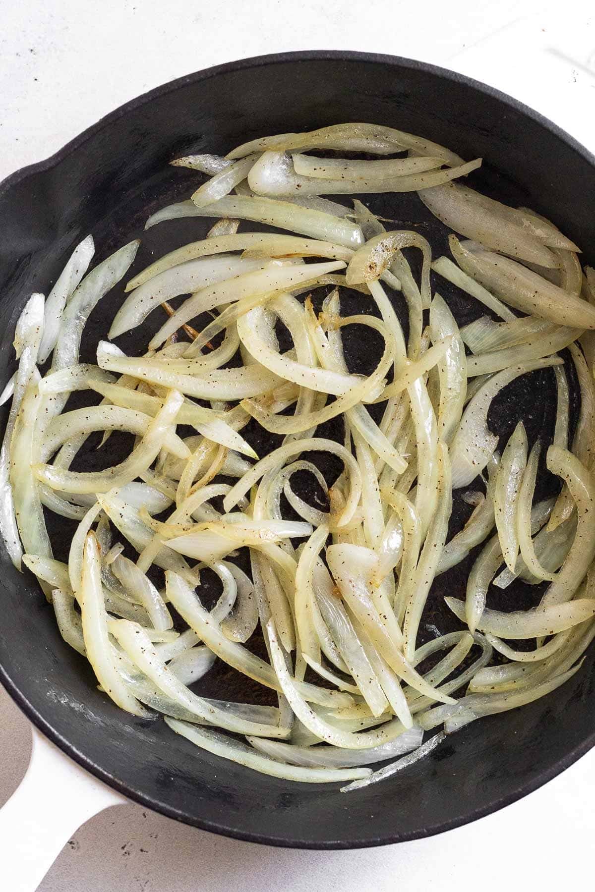 Sautéed onions in a cast iron skillet.