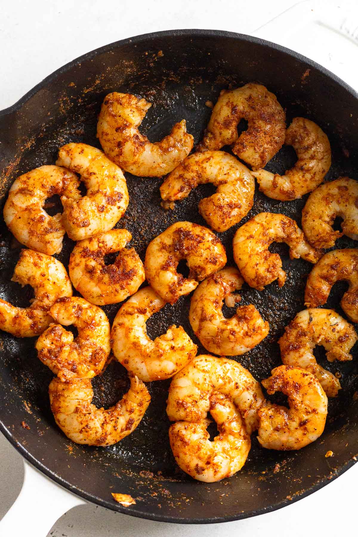 Sautéed shrimp in a cast iron skillet.