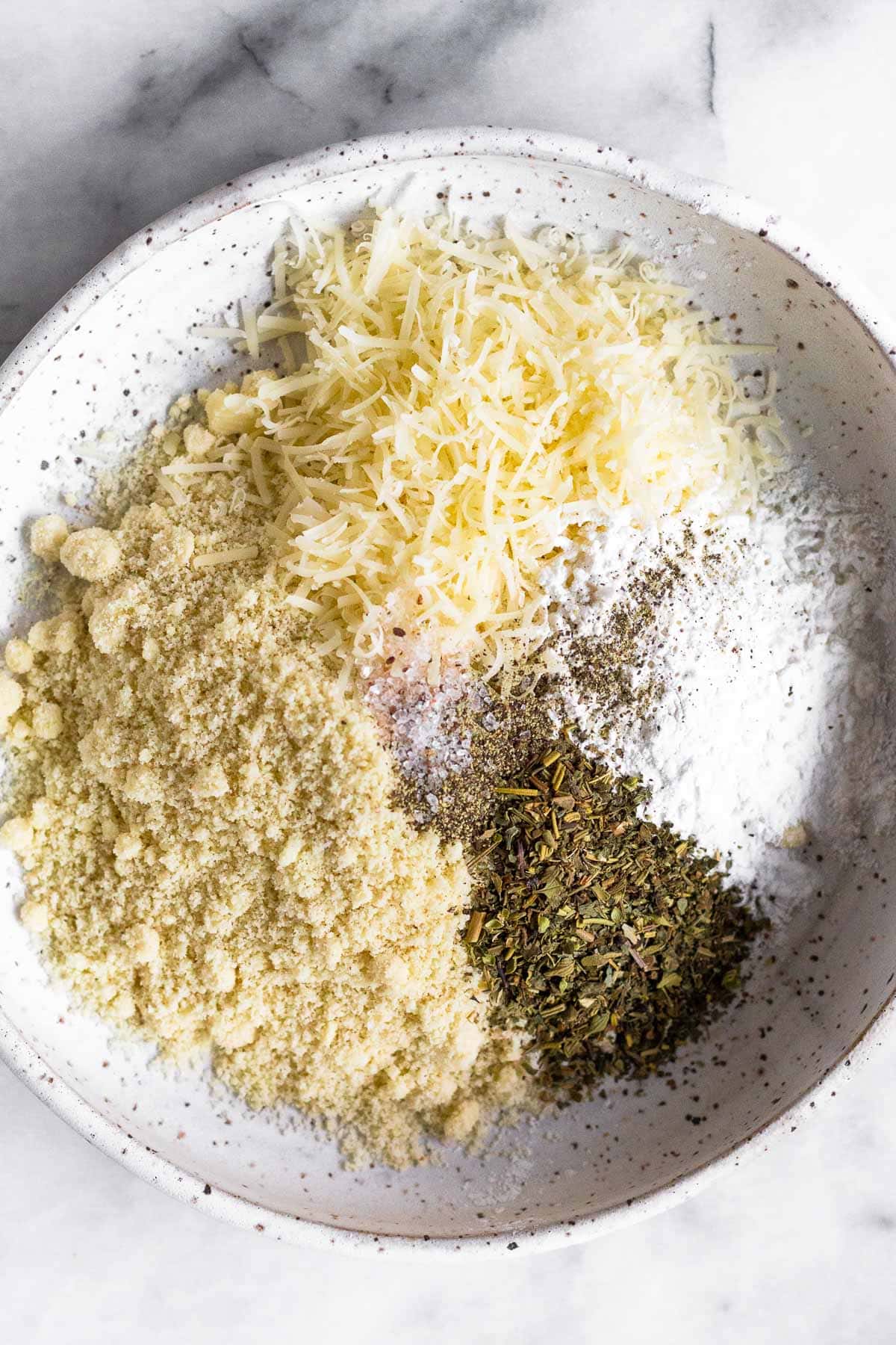 Bowl of almond flour, shredded cheese, tapioca flour, and spices.