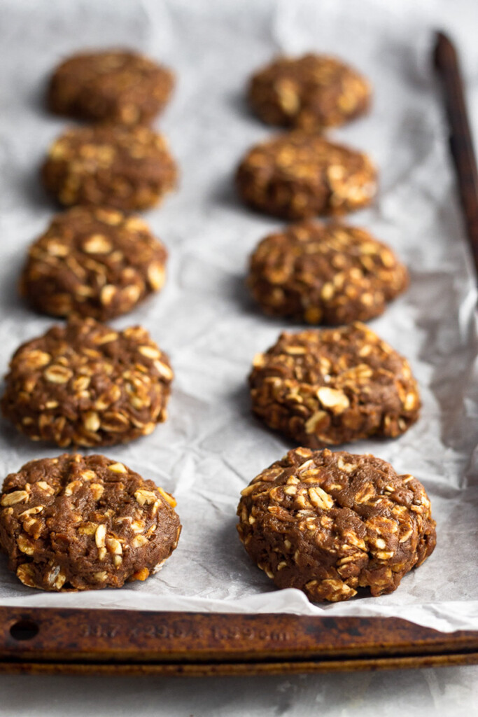 Protein powder no bake cookies on a baking sheet lined with parchment paper.
