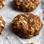 No bake protein cookies sprinkled with flaky sea salt on a baking sheet.
