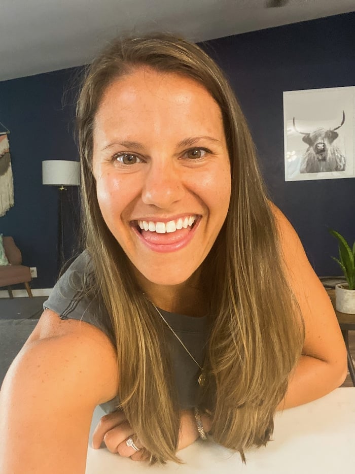 Picture of a woman taking a selfie with a big smile on her face