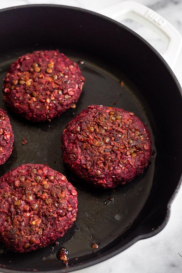 Pan of vegan beet burgers in a large cast iron skillet.