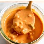 Burger sauce in a jar with a spoon overtop holding some.