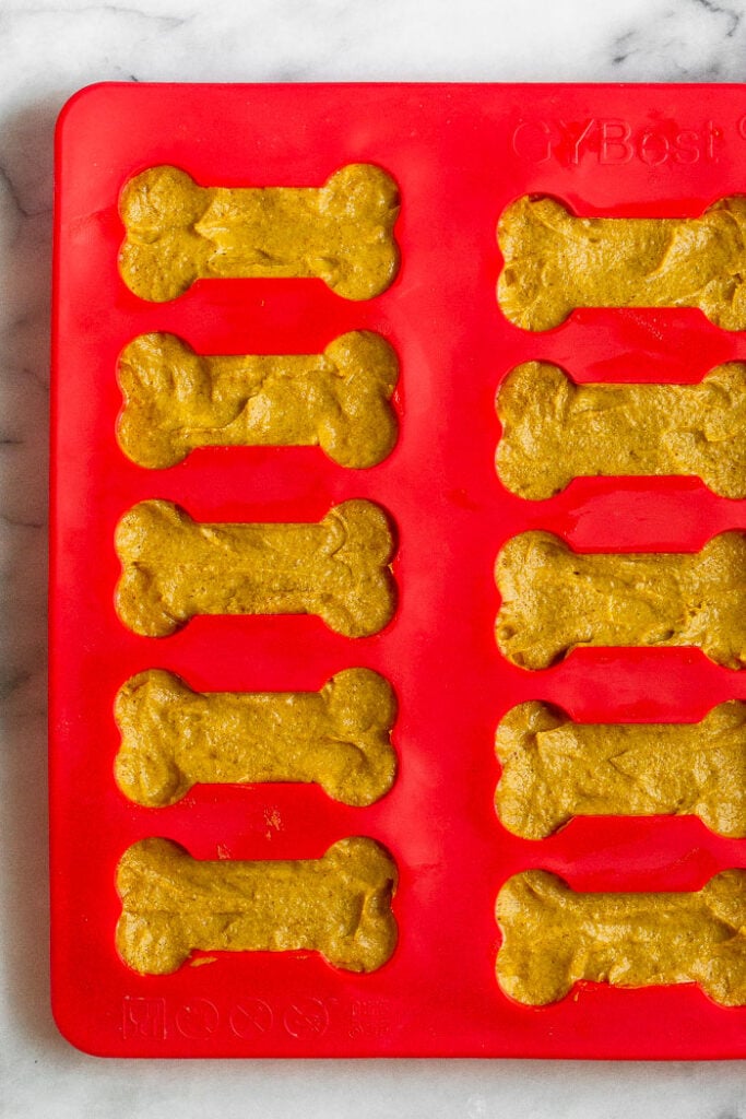 3 ingredient peanut butter dog treats in a bone-shaped silicone mold.