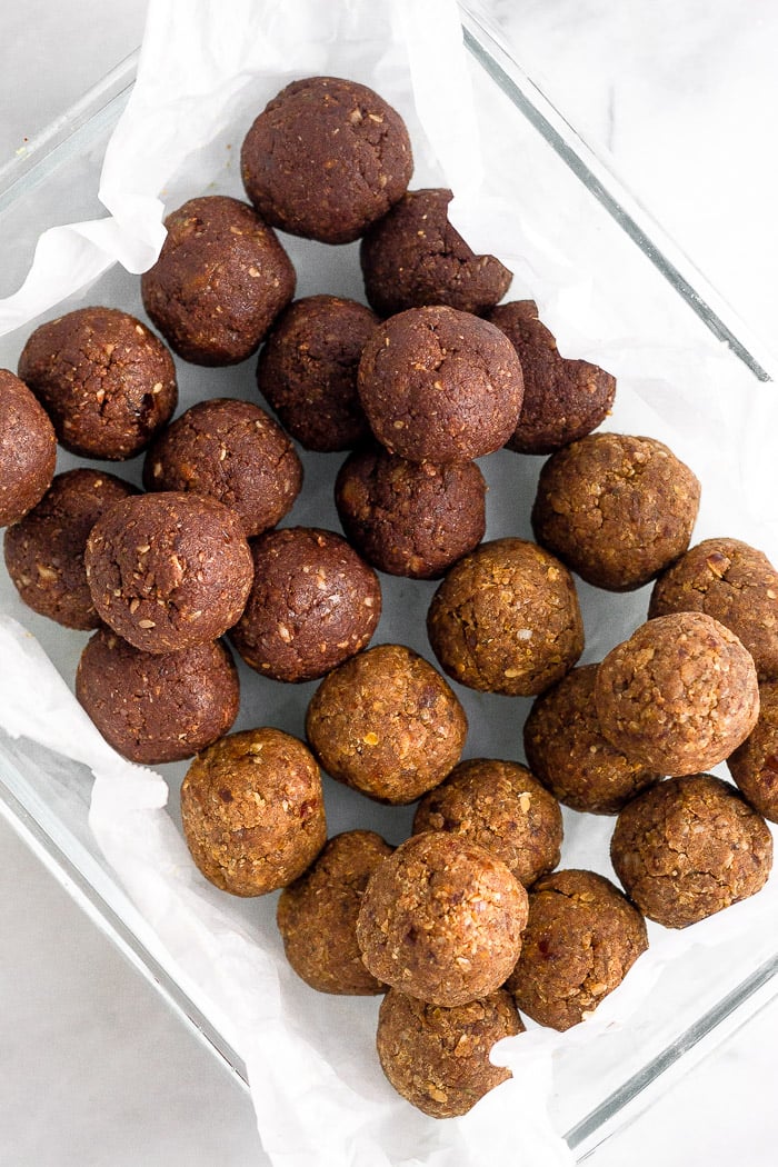 Glass rectangular container filled with 2 flavors of seed cycling energy balls.