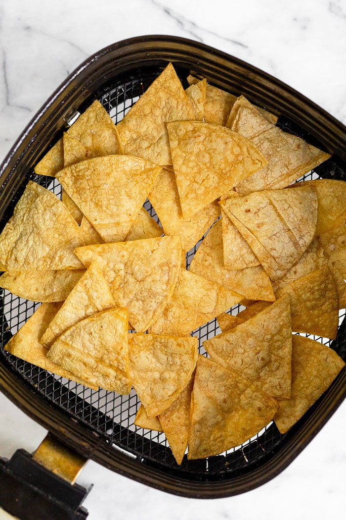 Tortilla chips in the air fryer basket.