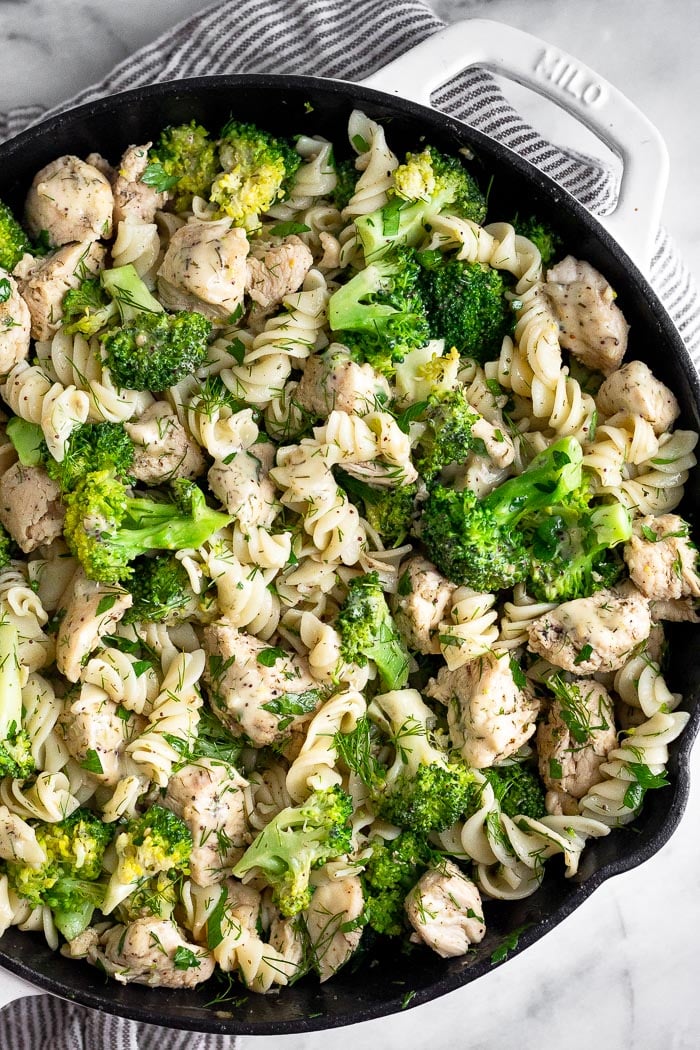Pan filled with chicken ranch pasta with broccoli and lots of herbs.