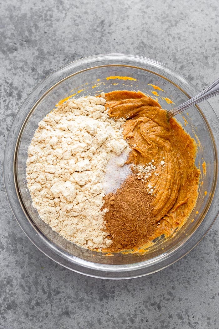Bowl filled with a mix of pumpkin and almond butter with protein powder and spices on top.
