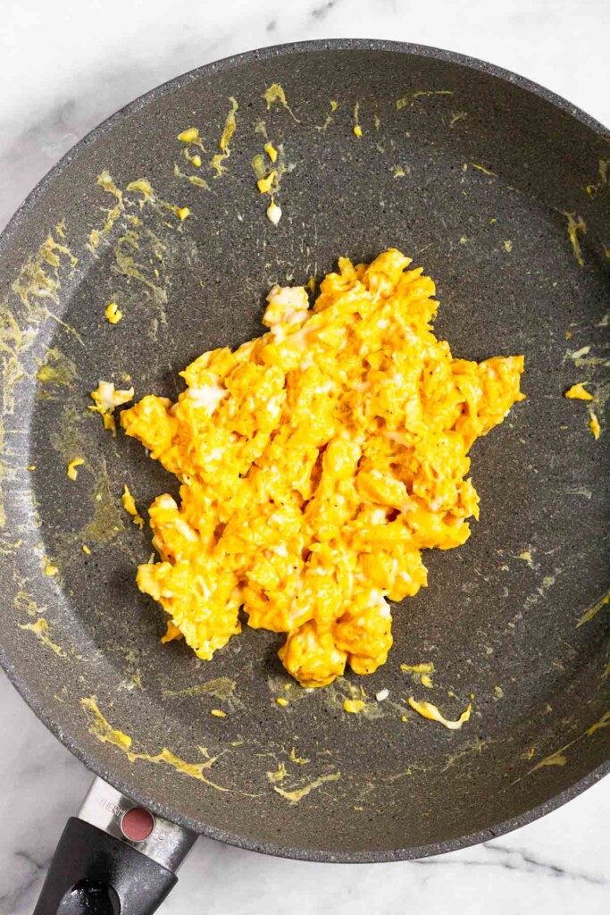 Scrambled eggs in a skillet.