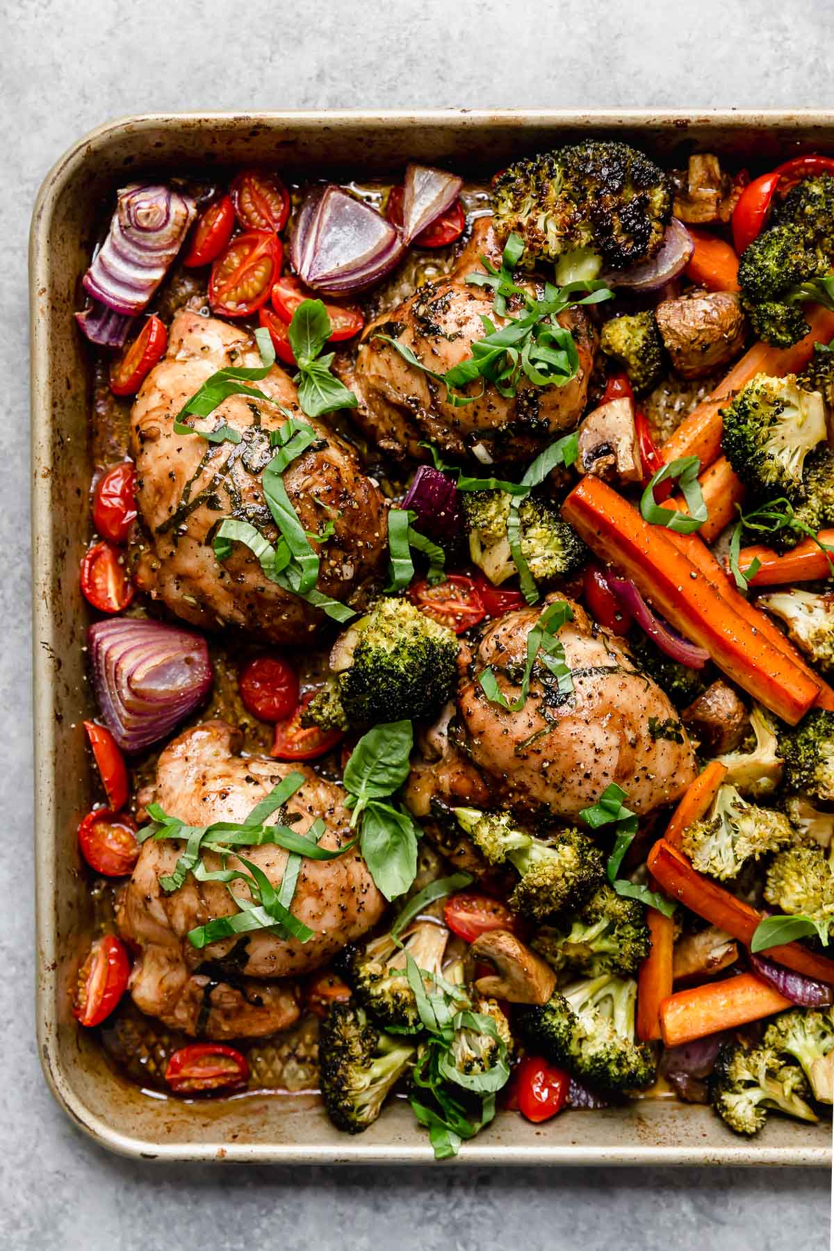 A sheet pan filled with balsamic chicken and veggies.