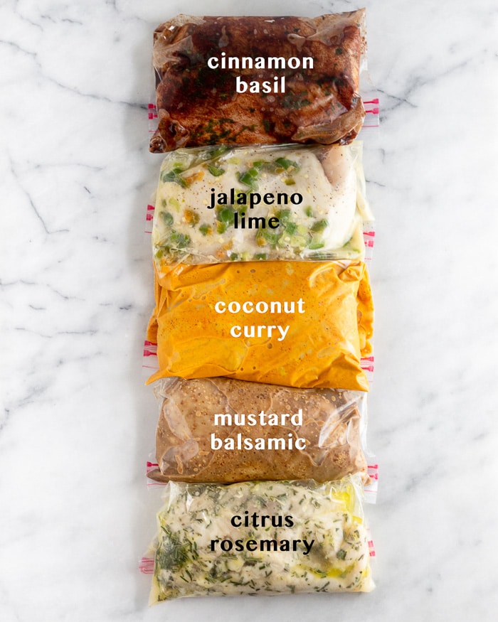 Five different Whole30 chicken marinades in plastic bags with text over each saying what they are.