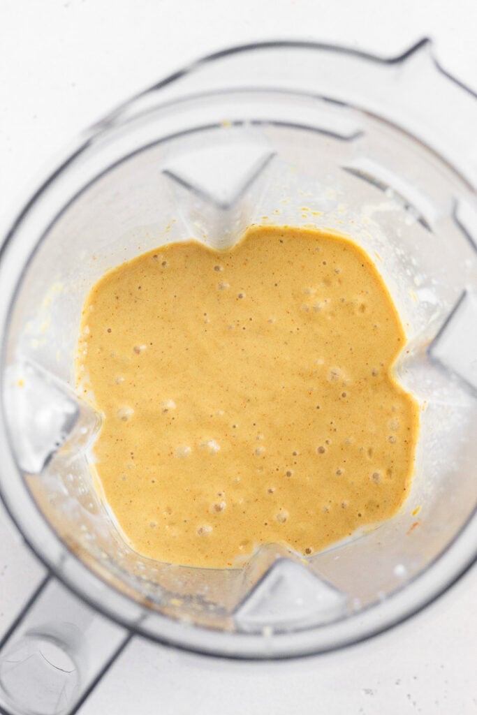 Blender filled with a dairy free creamy broth.