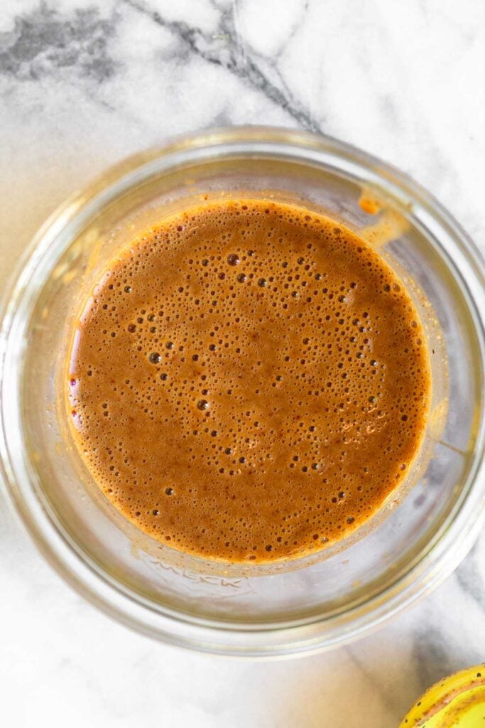 Small jar with creamy balsamic dressing in it.