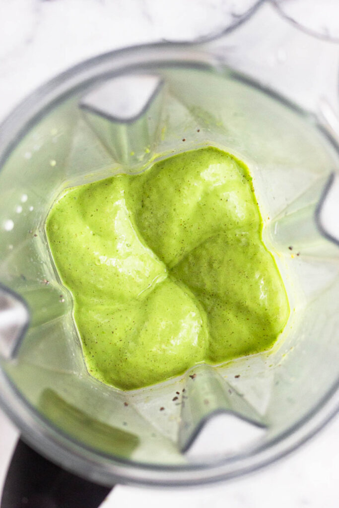 Overhead shot of pineapple green smoothie in a blender.