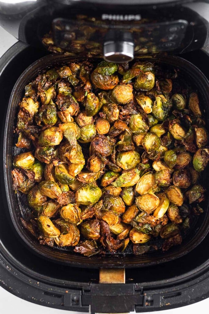 Overhead shot of roasted brussel sprouts in an air fryer.