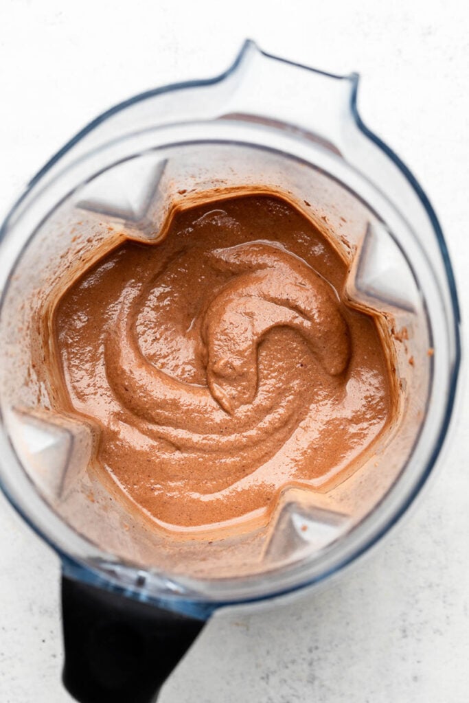 Overhead shot of a thick chocolate smoothie in a blender.