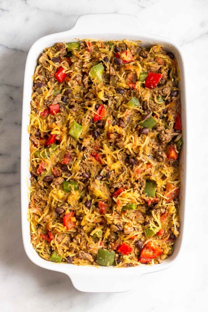 Spaghetti squash casserole with ground beef and peppers in a large casserole dish before it goes into the oven.