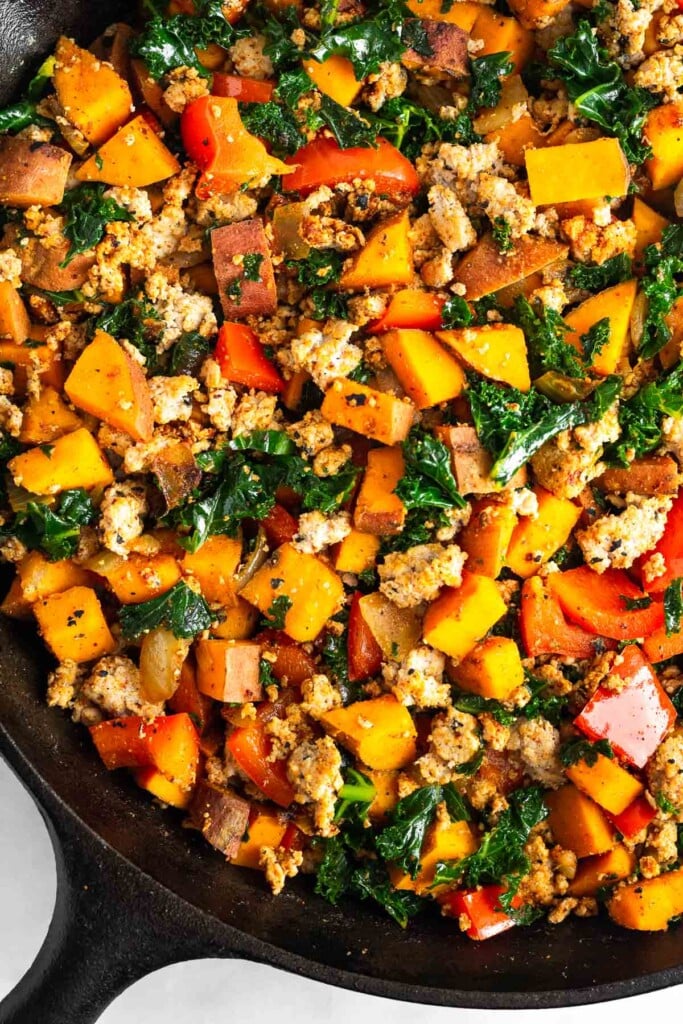 Large cast iron filled with ground turkey, sweet potatoes, and veggies.