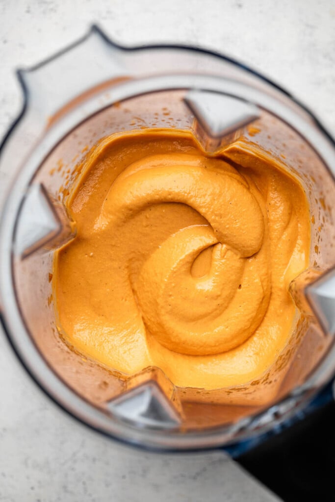 Blender filled with creamy vegan pasta sauce.