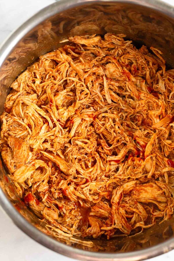 Instant Pot filled with shredded bbq chicken.