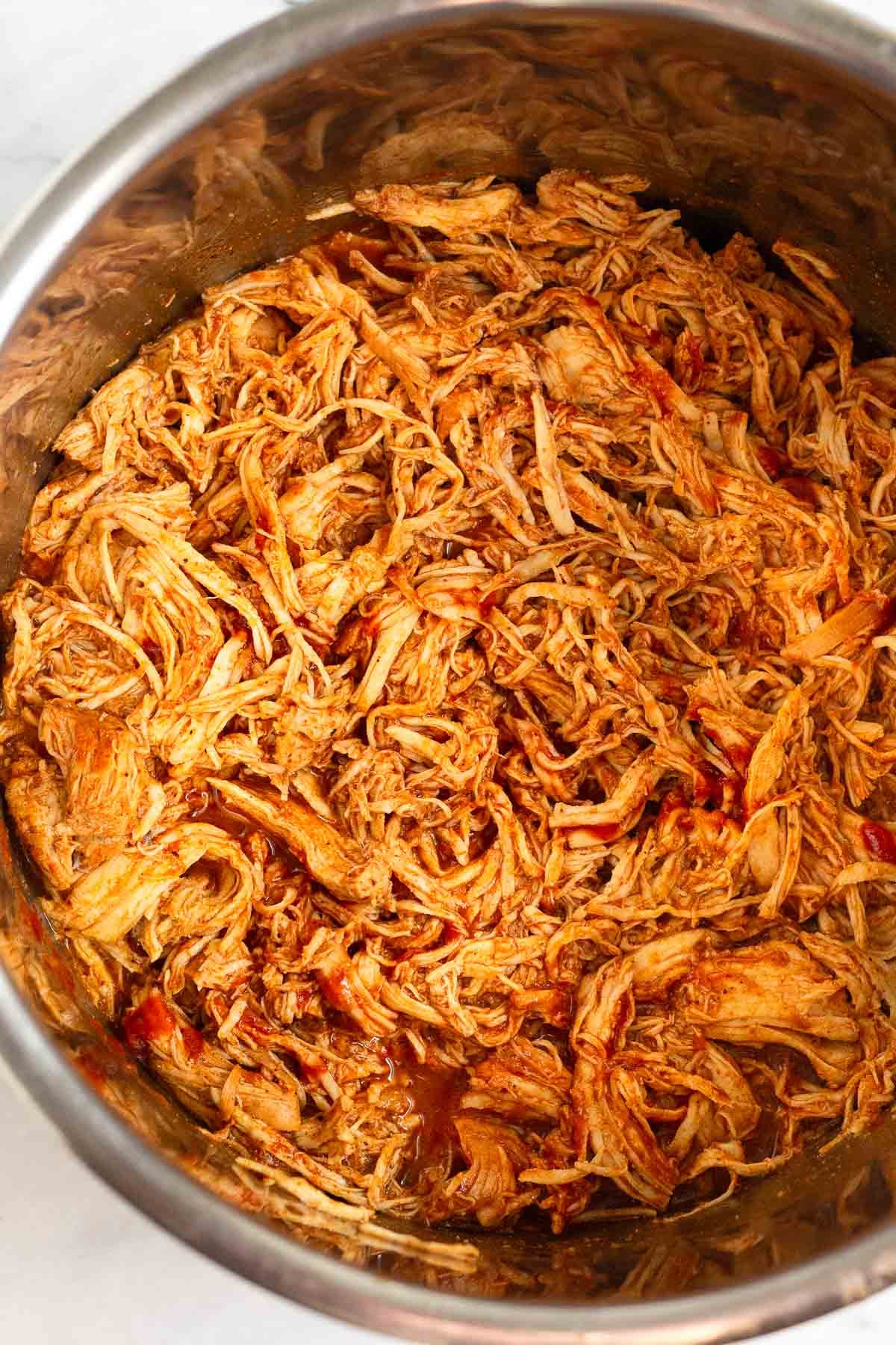 Instant Pot filled with shredded bbq chicken.