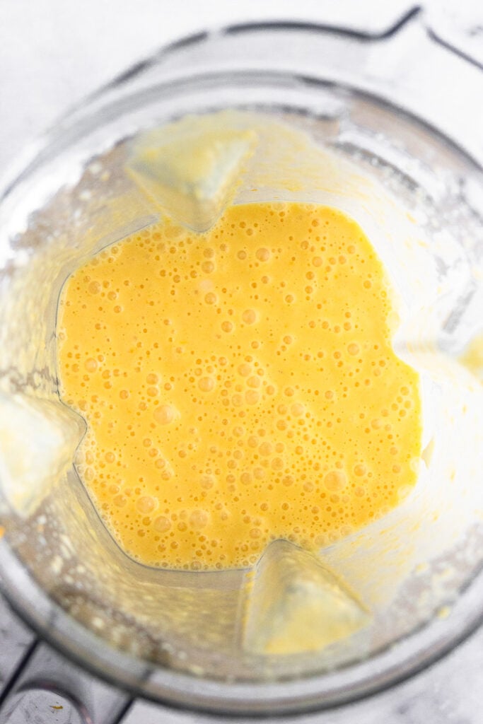 Orange creamsicle protein smoothie recipe in a blender.