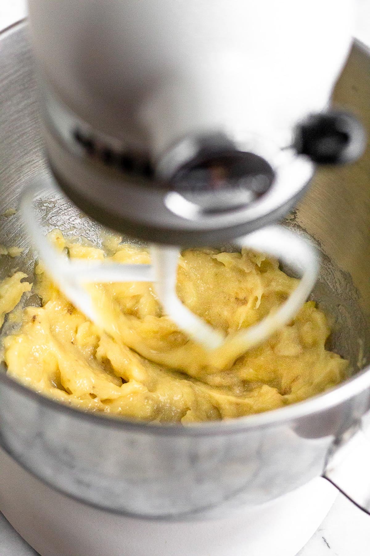 Mashed bananas in a stand mixer.