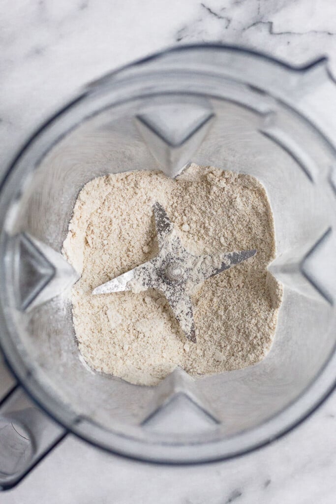 Blender filled with oat flour that has just been blended.