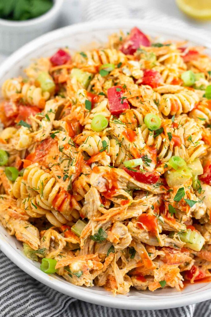 Close up of buffalo chicken salad pasta in a large bowl.