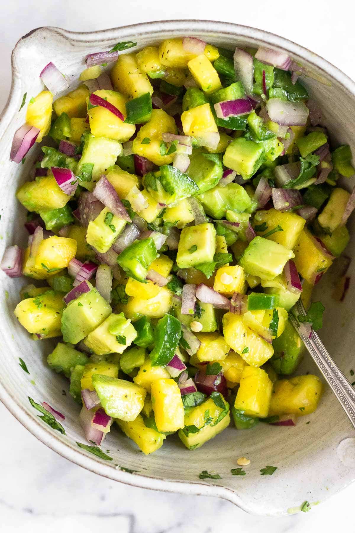 Bowl of pineapple and avocado salsa.