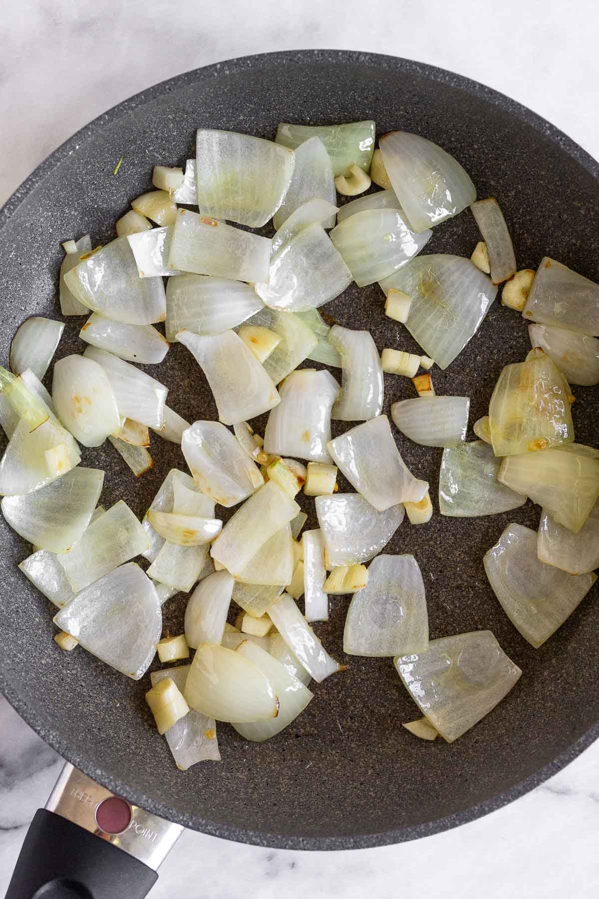 Saute pan with sautéed onion and garlic.
