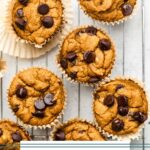 Overhead shot of pumpkin protein muffins on a metal cooling rack.