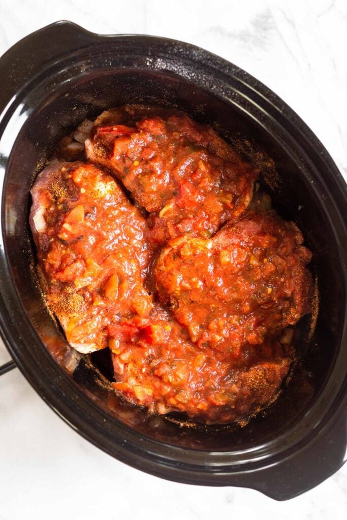 Crock pot pork chops before they are cooked.