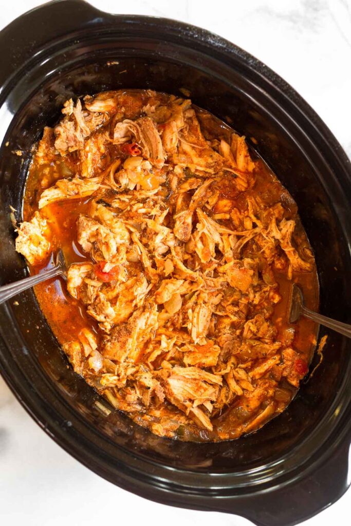 Salsa shredded pork chops in a crockpot.