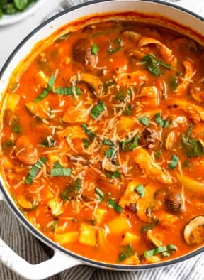 High protein soup with chicken and veggies in a tomato broth topped with fresh herbs and parmesan cheese.