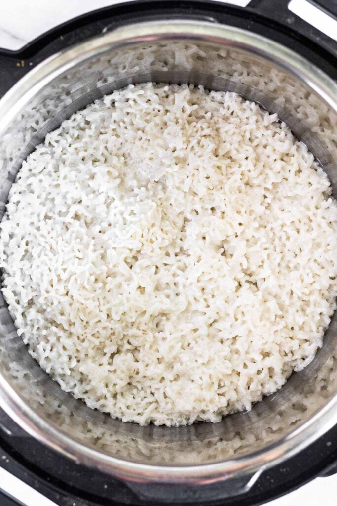Pressure cooker with coconut rice in it.