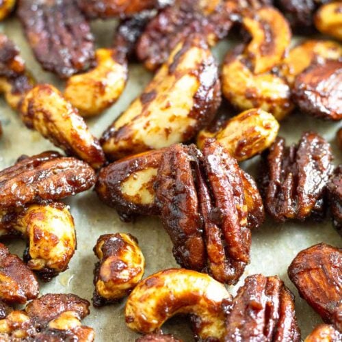 Close up of candied nuts on a large baking sheet.
