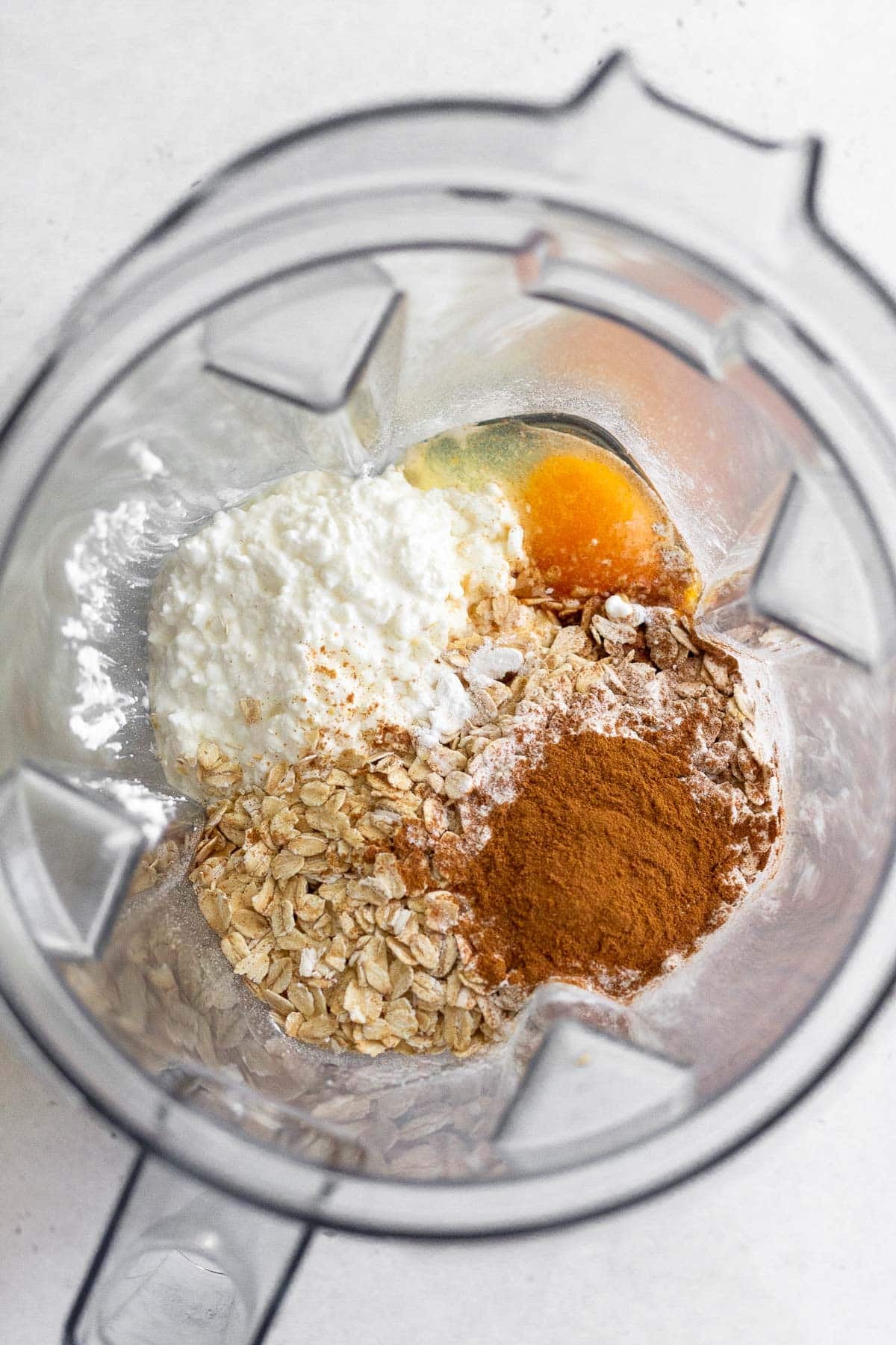 Blender with cottage cheese, eggs, oats, cinnamon, and baking powder.