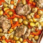 Sheet pan za'atar chicken with roasted potatoes, carrots, cauliflower, and red bell peppers.