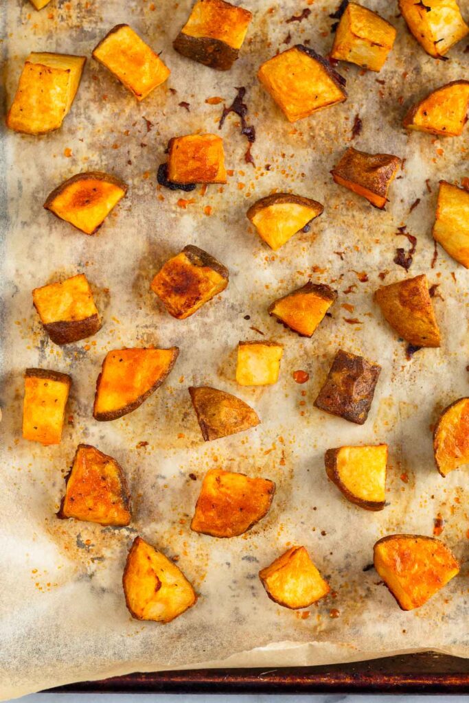 Roasted buffalo potatoes on a baking sheet.