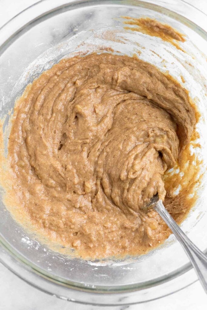 Cake batter in a large glass bowl with a fork in it.