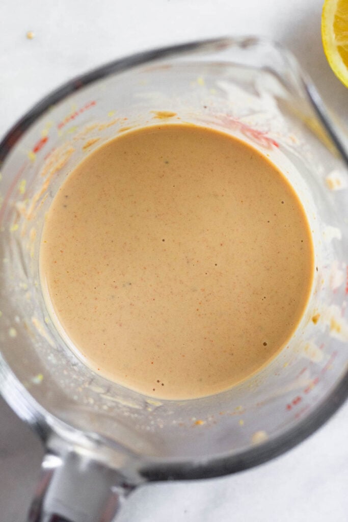 Tahini pasta sauce in a large measuring cup.
