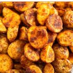 Plate full of breakfast potatoes piled on top of each other.