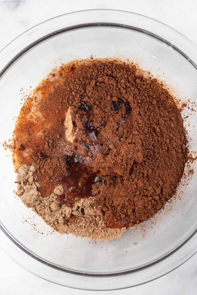 A glass bowl with ingredients for a batter before it is mixed.